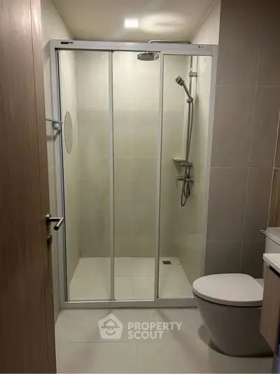 Modern bathroom with glass shower enclosure and sleek fixtures