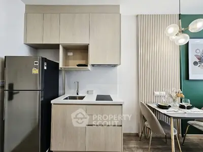 Modern kitchen with sleek cabinetry and dining area in stylish apartment