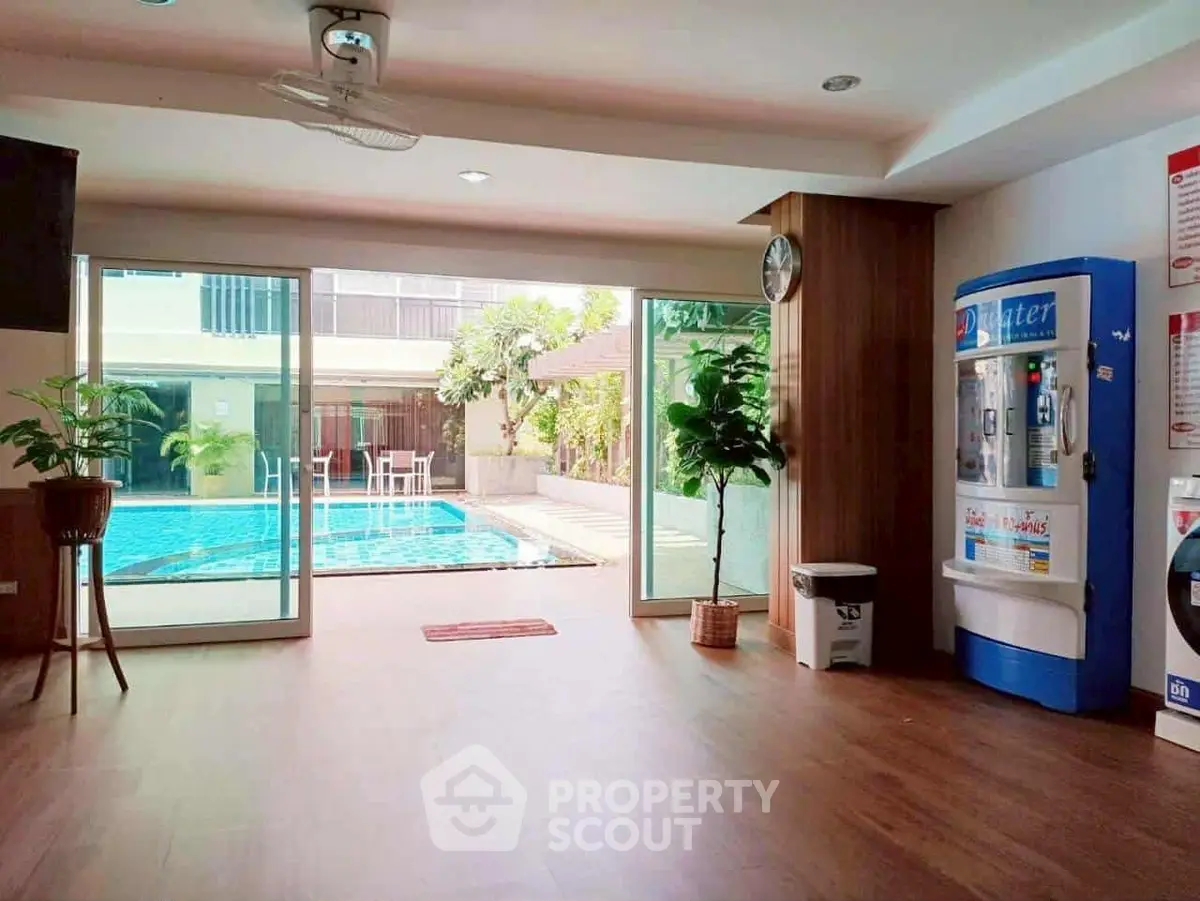 Spacious poolside area with modern amenities and sliding glass doors