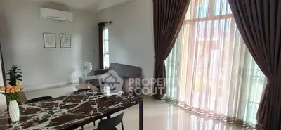 Spacious living room with modern decor and large windows for natural light.