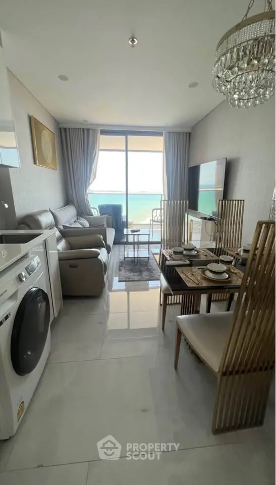 Luxurious beachfront living room with modern decor and stunning ocean view.