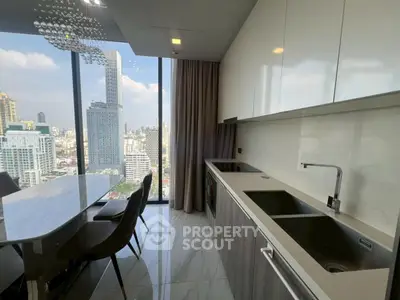 Modern kitchen with stunning city view, featuring sleek cabinetry and elegant dining area.