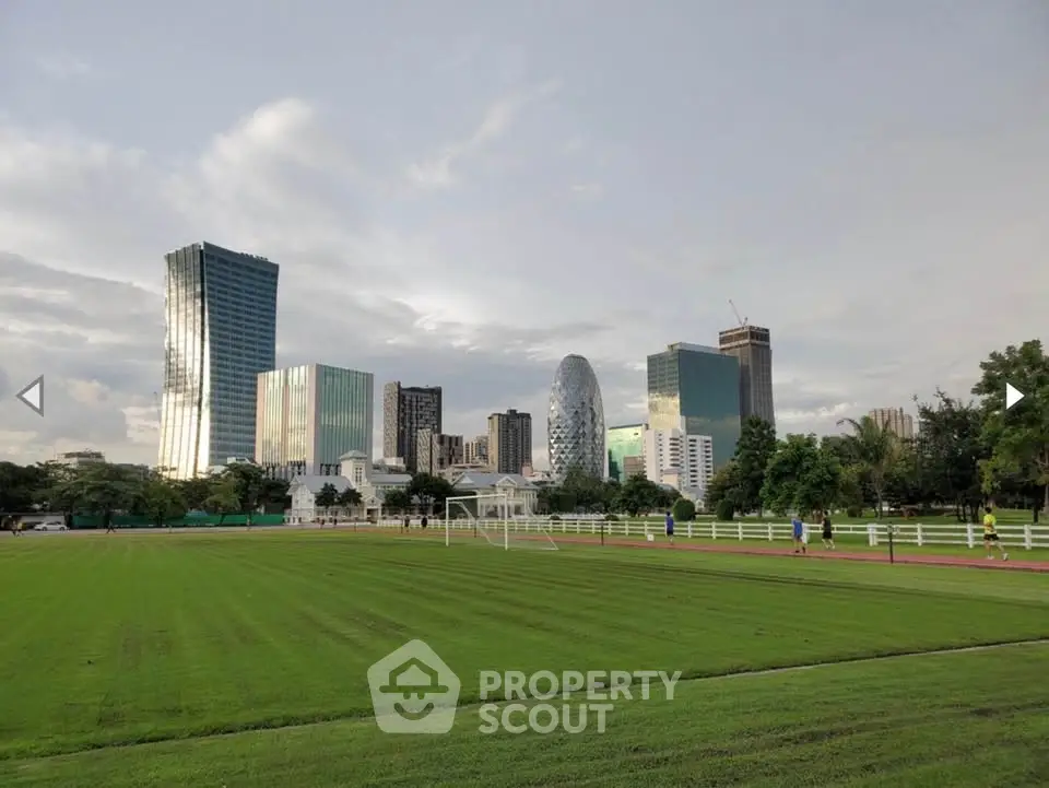 Stunning cityscape view with modern skyscrapers and lush green park, perfect for urban living enthusiasts.