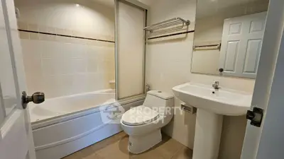 Modern bathroom with bathtub and sleek fixtures in a contemporary home.