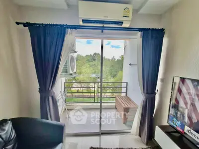 Cozy living room with balcony view and air conditioning in modern apartment.