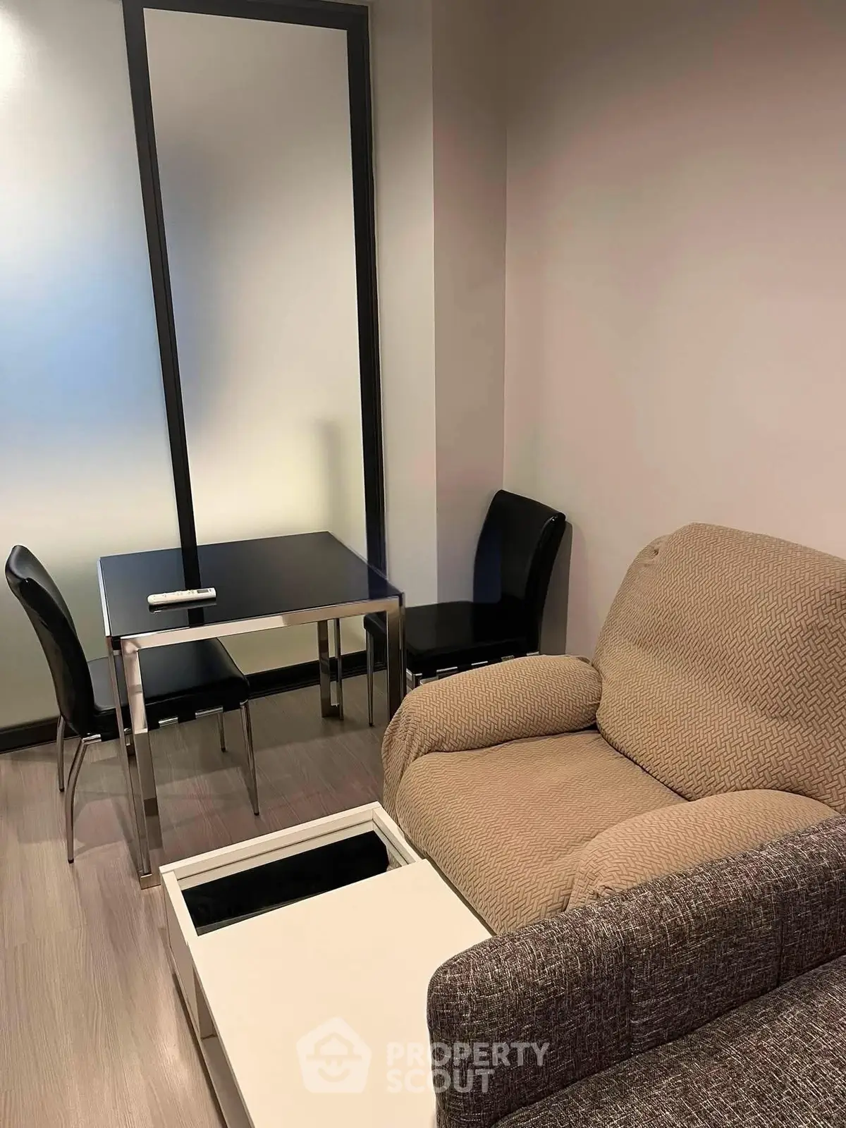 Cozy living room with modern furniture and sleek design, perfect for relaxation and entertainment.