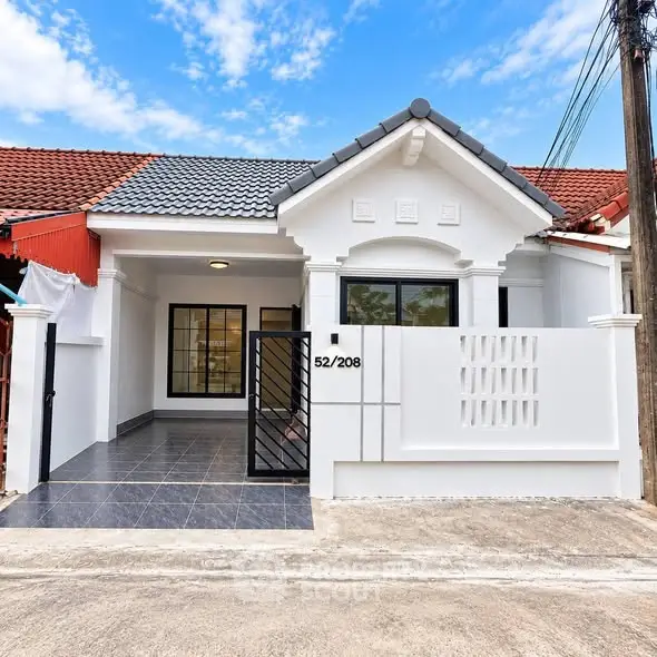 Charming single-story house with modern facade and tiled front patio, perfect for cozy living.