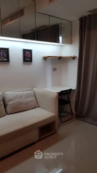 Cozy living room with modern decor and a small study nook, perfect for urban living.
