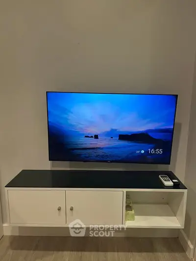 Modern living room with sleek wall-mounted TV and stylish console table.