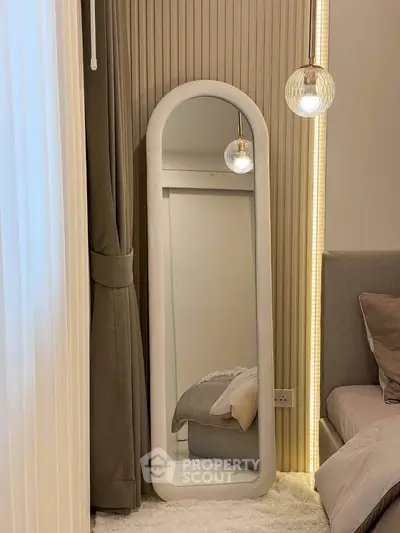 Elegant bedroom corner with full-length mirror and modern lighting
