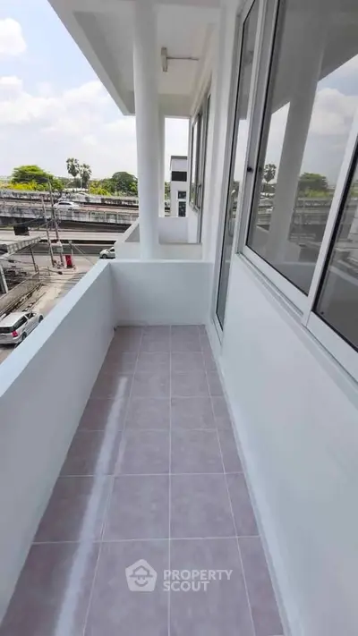 Spacious balcony with city view in modern apartment building