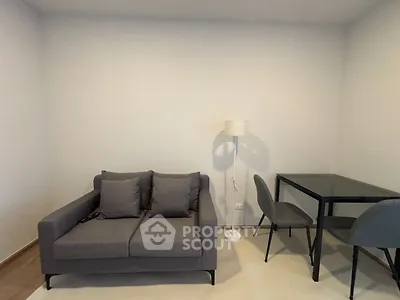 Modern living room with stylish gray sofa and sleek dining table set
