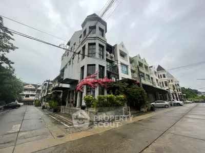Modern townhouse exterior with unique architectural design and lush greenery