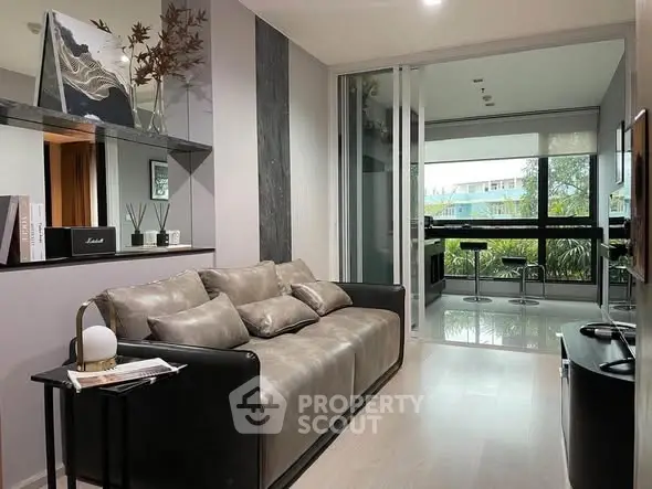 Modern living room with sleek decor and large window view