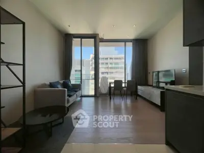 Modern living room with large windows and city view, featuring sleek furniture and open layout.