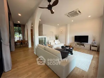 Spacious modern living room with elegant decor and open layout, featuring a cozy seating area and stylish dining space.