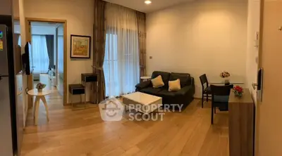 Modern living room with wooden flooring, cozy seating, and elegant decor in a stylish apartment.