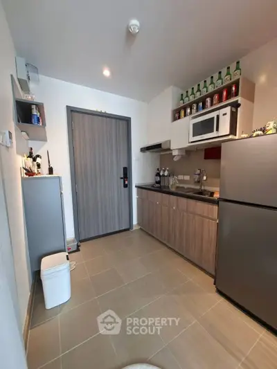 Modern kitchen with sleek cabinets, stainless steel appliances, and stylish decor in a contemporary apartment.