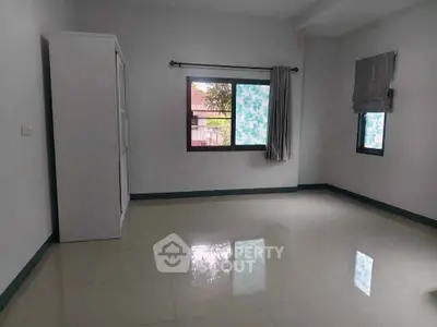 Spacious unfurnished room with large windows and glossy tiled floor