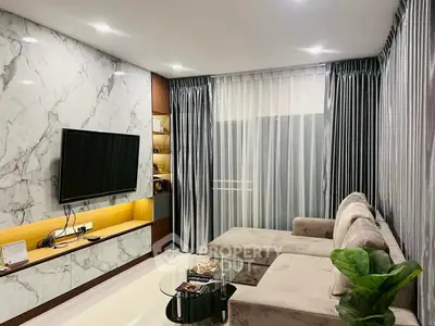 Elegant living room with marble wall, cozy sofa, and modern decor
