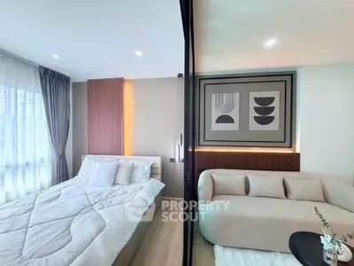 Modern bedroom with cozy bed and stylish sofa in a well-lit space.