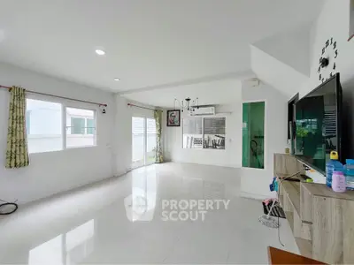 Spacious modern living room with large windows and sleek decor