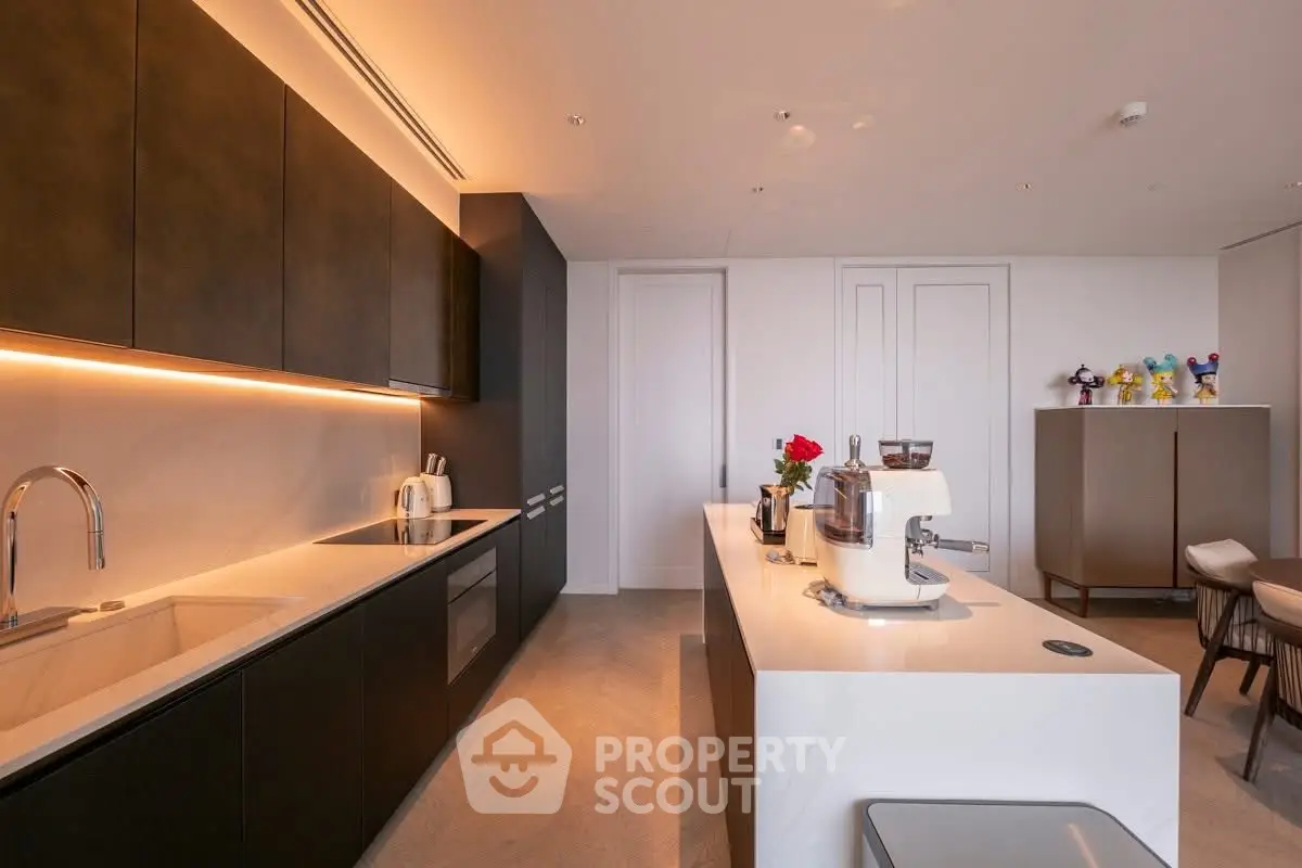 Luxurious modern kitchen with sleek cabinetry and island in upscale apartment
