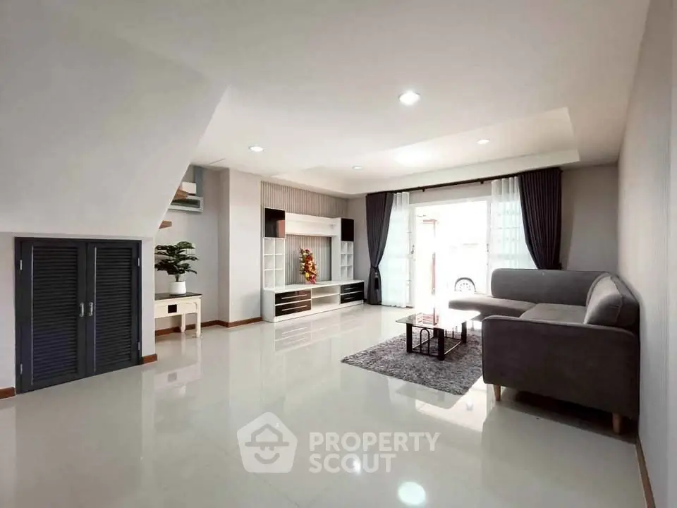 Spacious modern living room with sleek design and ample natural light