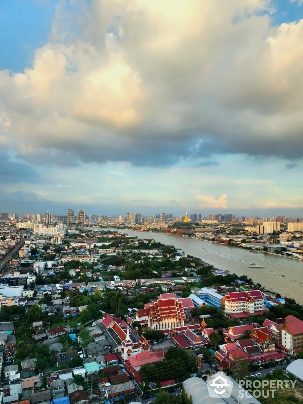 Stunning aerial view of cityscape with river and skyline at sunset, perfect for urban living enthusiasts.