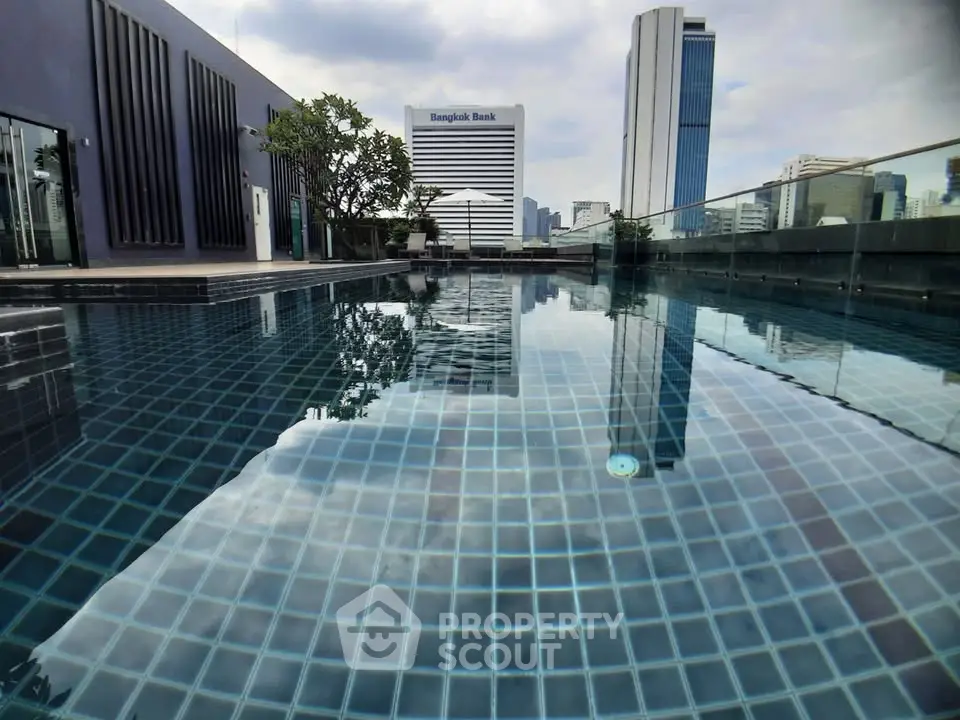 Stunning rooftop pool with city skyline view in modern urban setting.