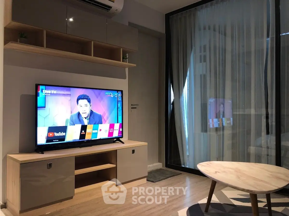 Modern living room with sleek TV setup and stylish furniture, perfect for entertainment and relaxation.