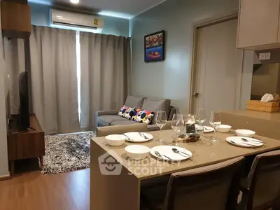 Modern living room with dining area, featuring stylish decor and cozy seating.