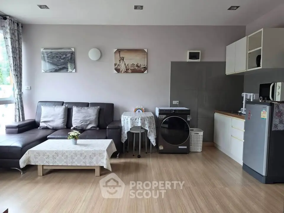 Modern living room with stylish furniture and integrated kitchen appliances