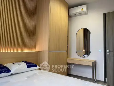 Modern bedroom with wooden accents and air conditioning in a stylish apartment.