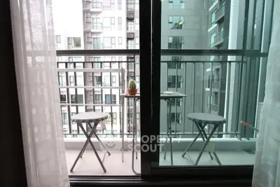 Modern balcony with city view, featuring sleek furniture and glass railing, perfect for urban living.