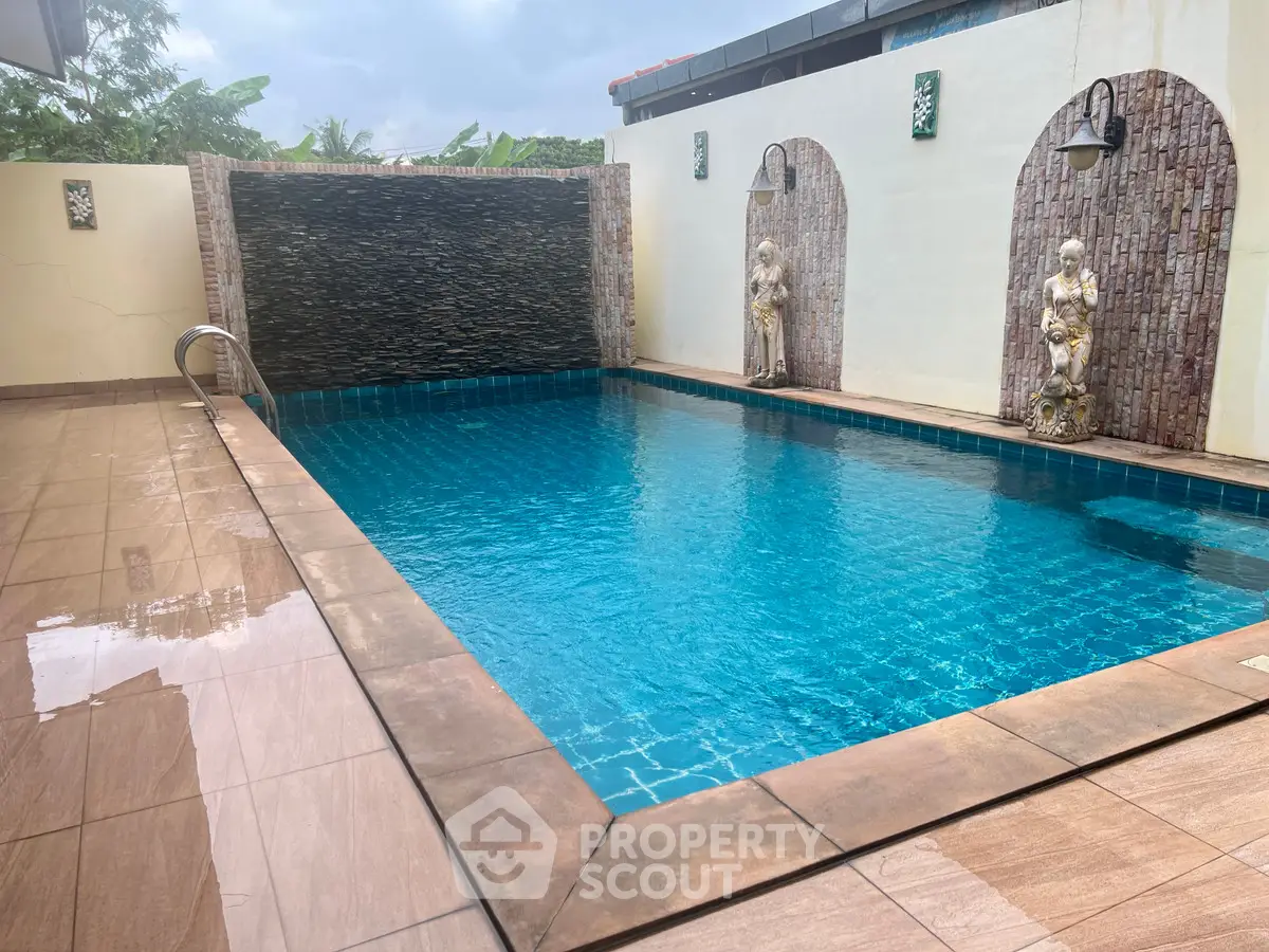 Luxurious private pool with elegant statues and serene water feature in a stylish outdoor setting.