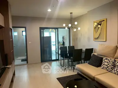 Modern living room with stylish decor and dining area in open layout apartment.
