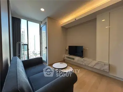 Modern living room with city view, featuring sleek furniture and natural light.