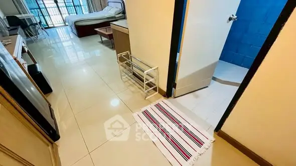 Spacious apartment interior with tiled floors and modern furnishings