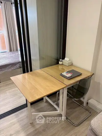 Modern study area with wooden desk and transparent chair in a stylish apartment