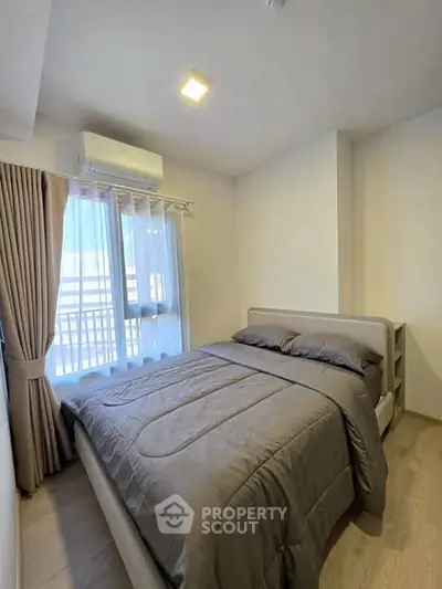 Cozy bedroom with natural light and modern decor in a stylish apartment.