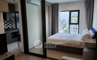 Modern bedroom with city view and adjacent kitchen in stylish apartment