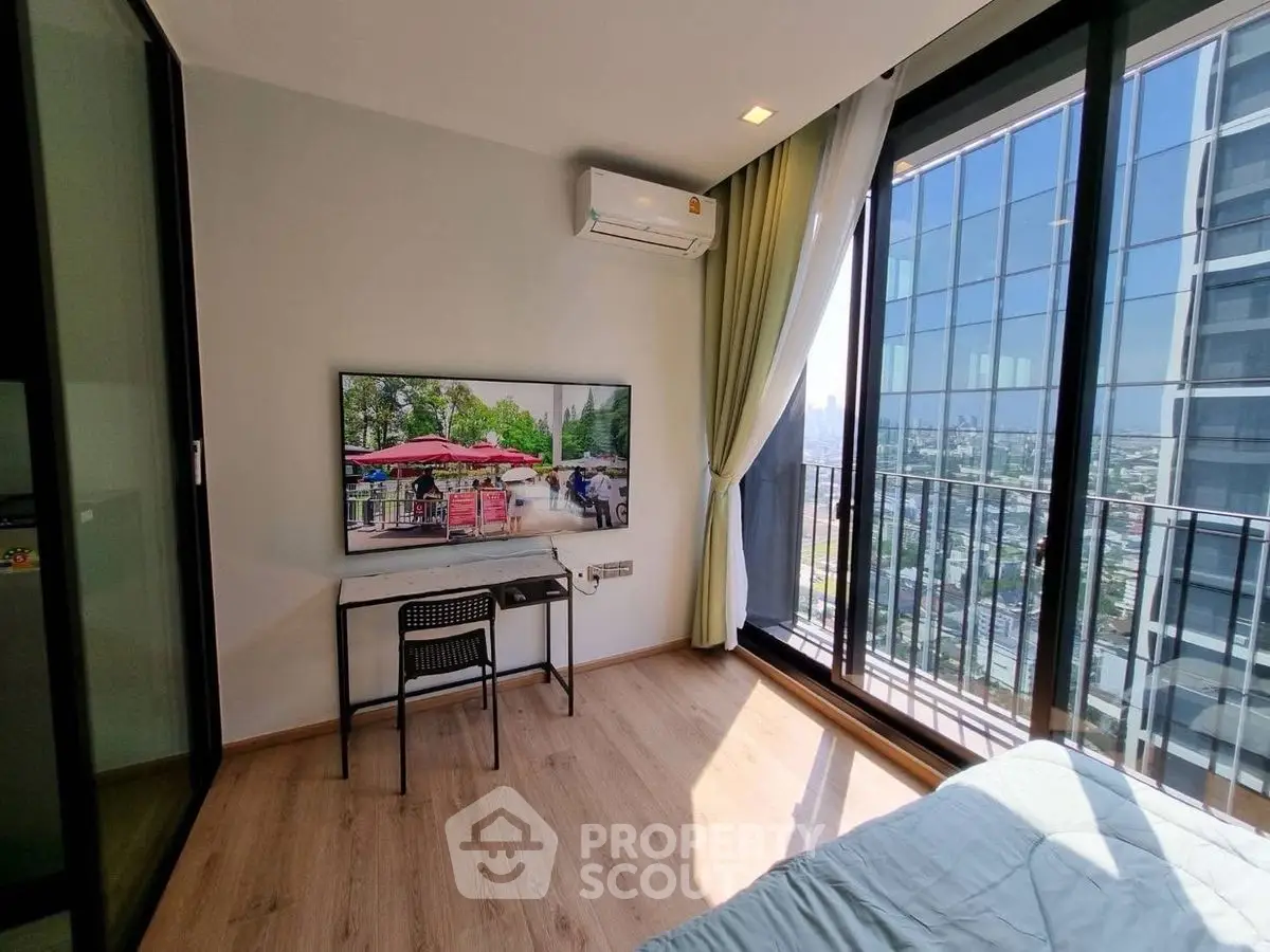 Modern bedroom with floor-to-ceiling windows and city view, featuring a wall-mounted TV and air conditioning.