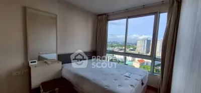 Spacious bedroom with city view and large windows in modern apartment