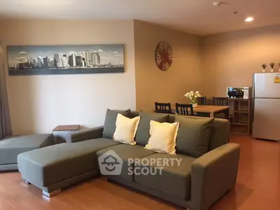 Spacious living room with modern decor and cozy seating in a stylish apartment.