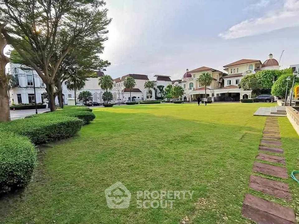 Luxurious residential area with manicured lawns and elegant architecture.