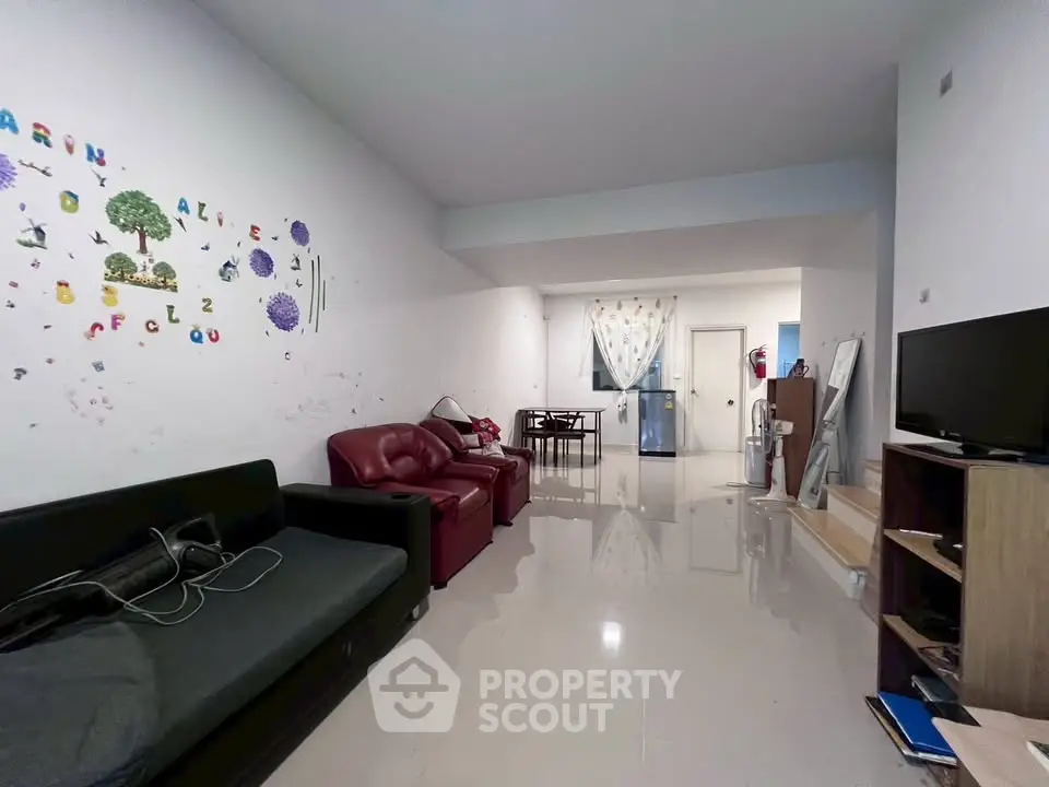 Spacious living room with modern furniture and open layout, perfect for family gatherings.