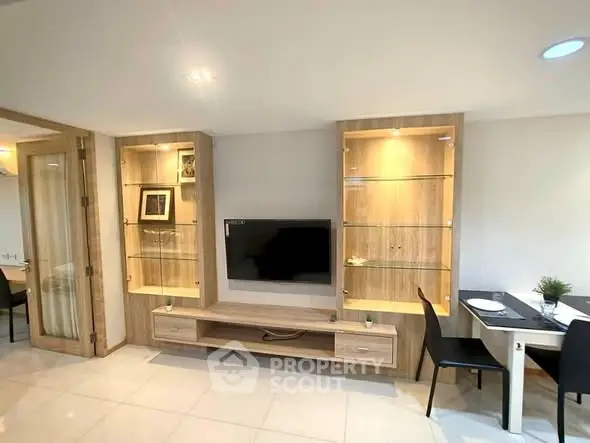 Modern living room with built-in wooden shelves and flat-screen TV