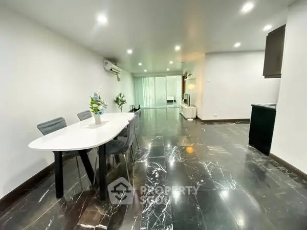 Spacious modern living room with elegant marble flooring and stylish dining area.