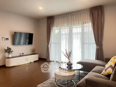 Modern living room with elegant decor and large window curtains